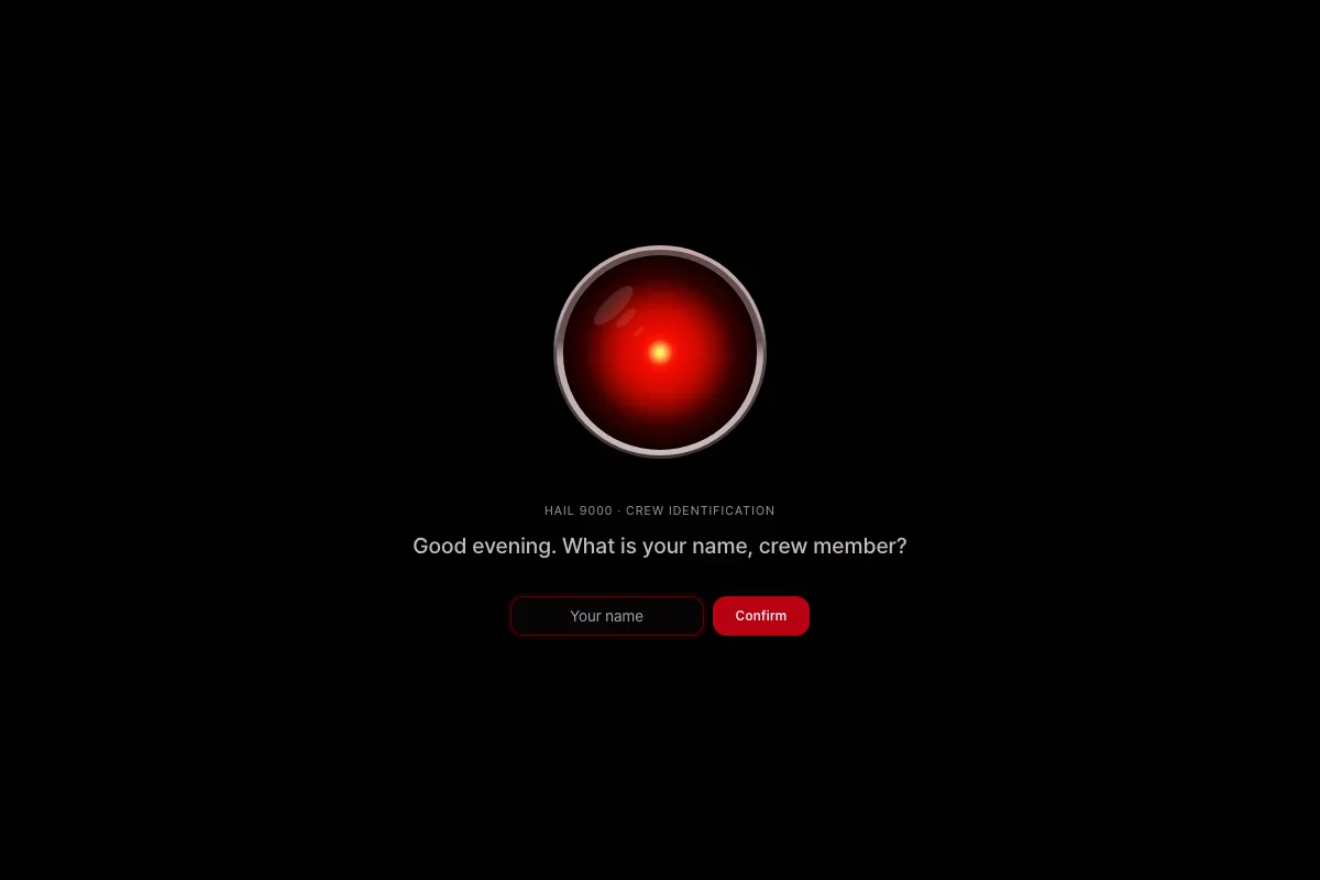 Black screen with a glowing red HAL 9000-style eye, a crew identification prompt, and a name input field with a red Confirm button
